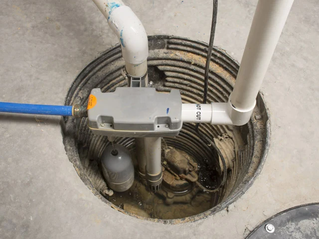 A sewage ejector pump installed in a basement pit.