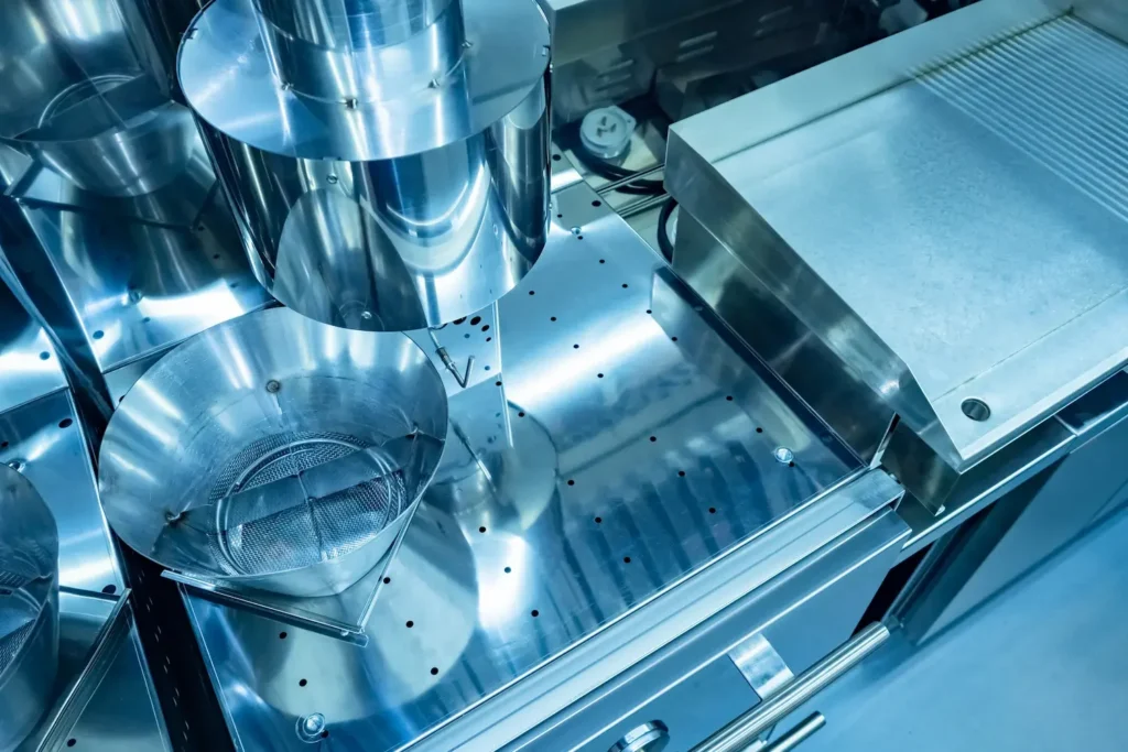 The stainless steel baffles of a commercial kitchen grease trap.