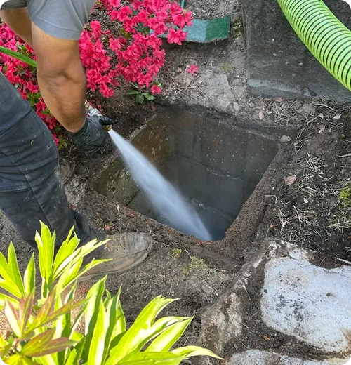 A high pressure water jet clearing out the inside of a distribution box.